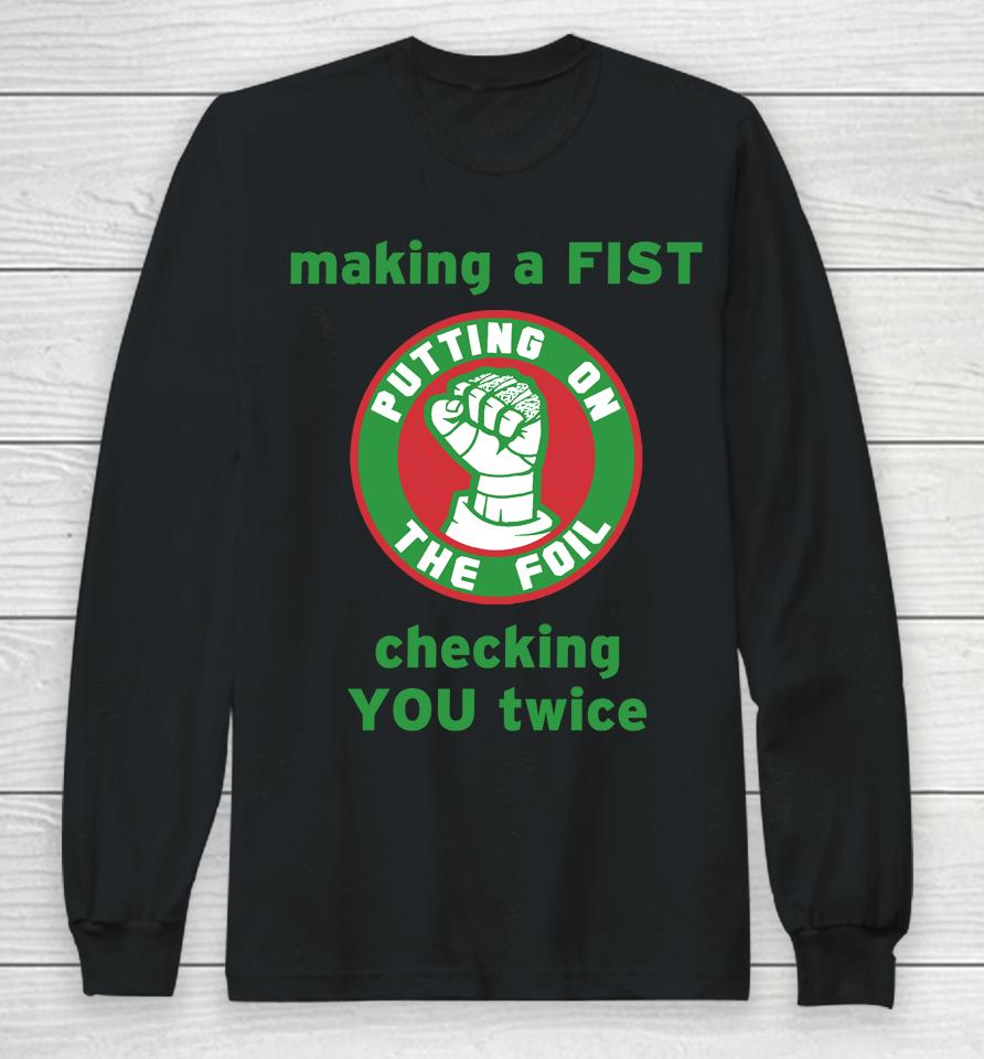 Making A Fist Putting On The Foil Long Sleeve T-Shirt